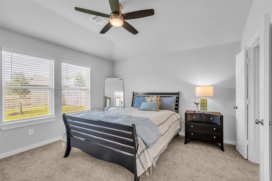 Lovely primary bedroom with views of the back yard.