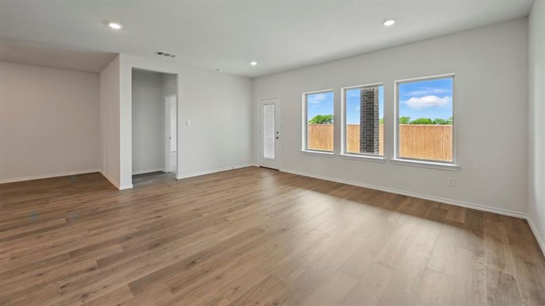 Empty room with wood finished floors and recessed lighting