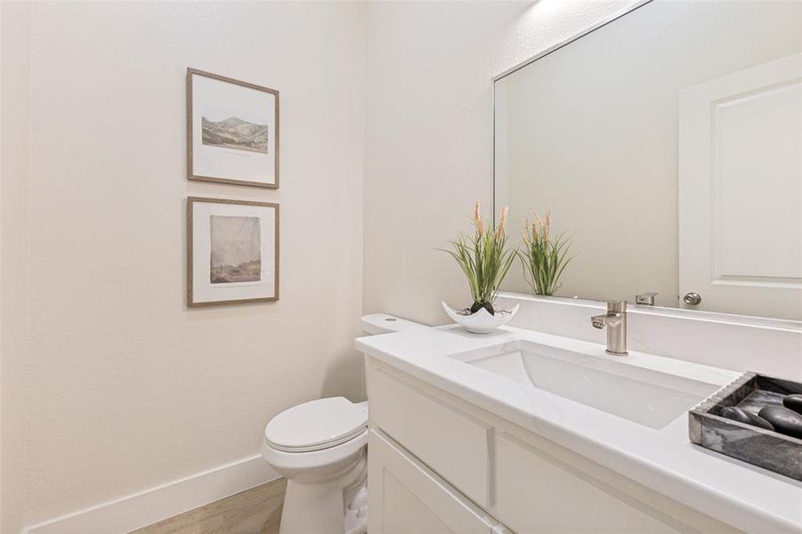 Bathroom featuring a contemporary vanity with a rectangular undermount sink, a polished chrome faucet, and a large wall-mounted mirror