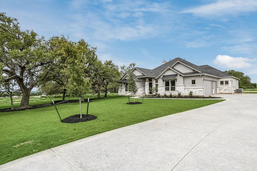 Front exterior of a new home in Leander Estates, Leander, TX, highlighting curb appeal (Image 21).