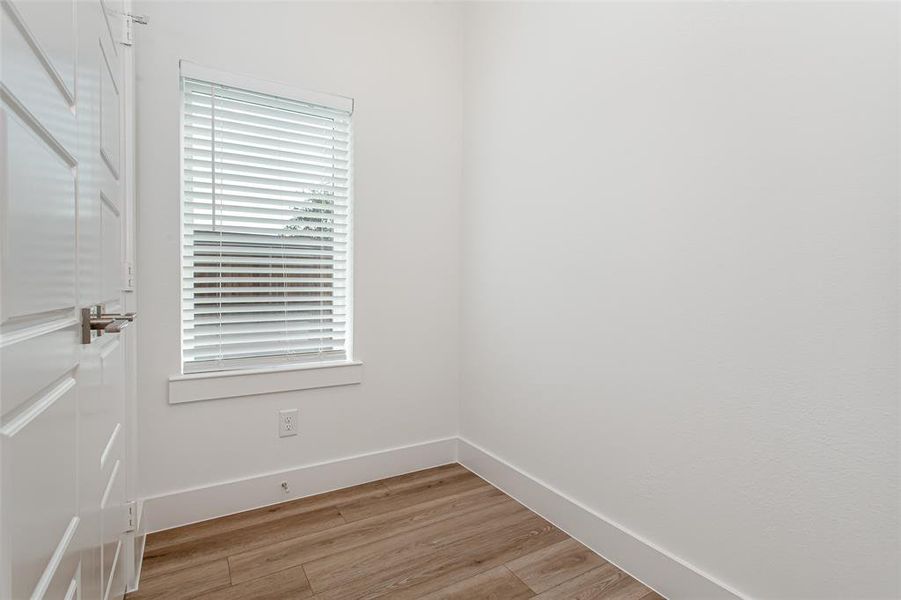Empty room featuring light wood-type flooring and baseboards