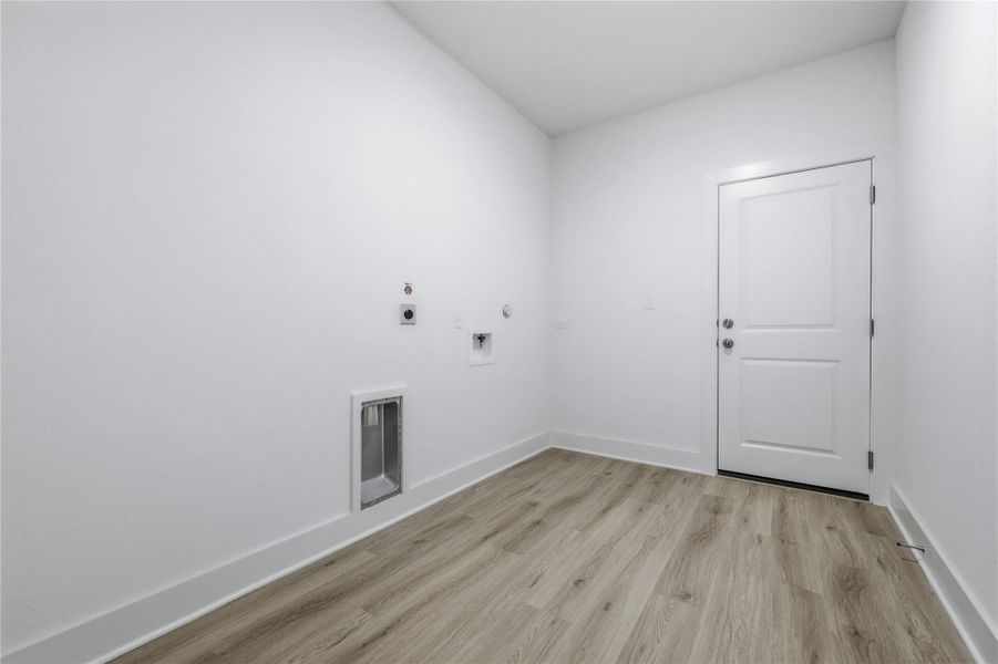Laundry room featuring light wood finished floors, gas dryer hookup, electric dryer hookup, and hookup for a washing machine