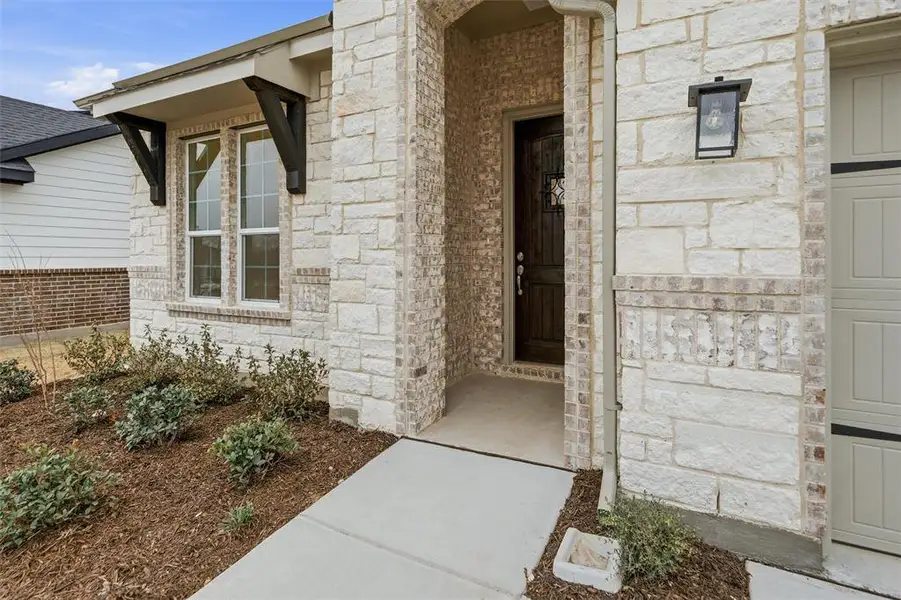 View of exterior entry with stone siding