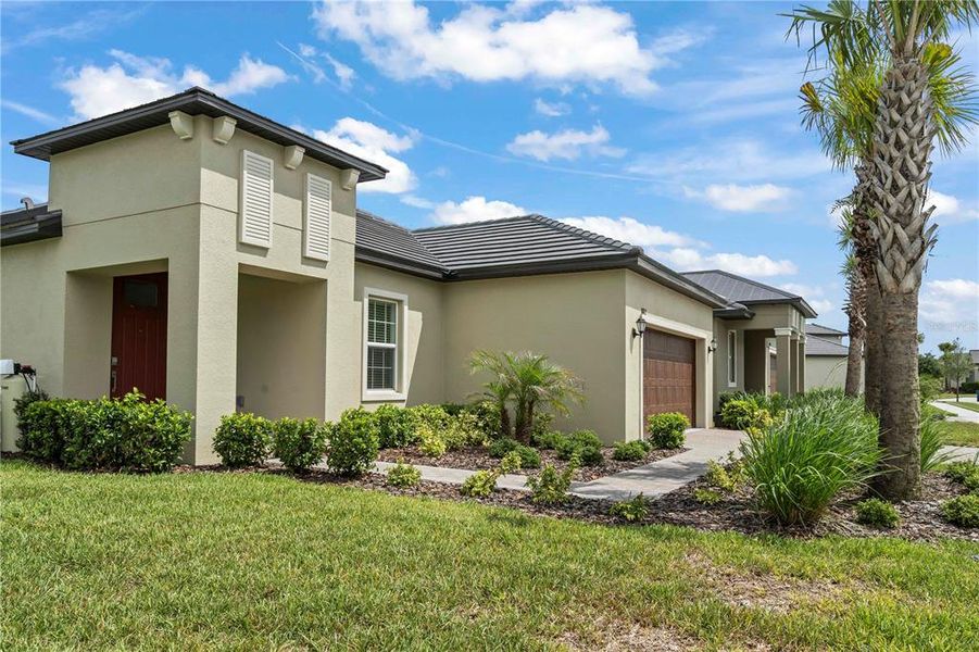 Front exterior of a new home in Angeline Active Adult, Land O' Lakes, FL, highlighting curb appeal (Image 24). Front exterior of a new home in Angeline Active Adult, Land O' Lakes, FL, highlighting curb appeal (Image 24).