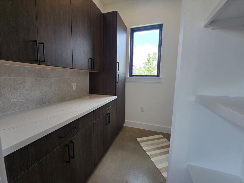 Large butler's pantry/utility room with more storage, and set up for 2 stackable washer and dryer systems side by side (4 machines total).