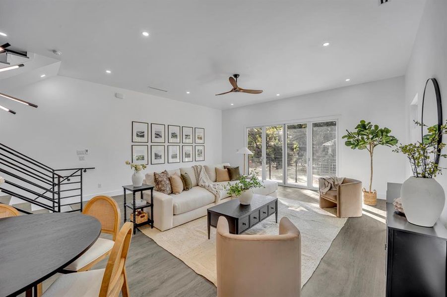 Living room with light hardwood / wood-style flooring and ceiling fan