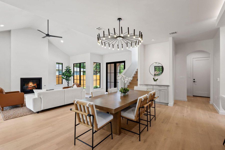Natural light floods this inviting space, highlighting wide plank flooring and a sleek fireplace. Natural light floods this inviting space, highlighting wide plank flooring and a sleek fireplace.
