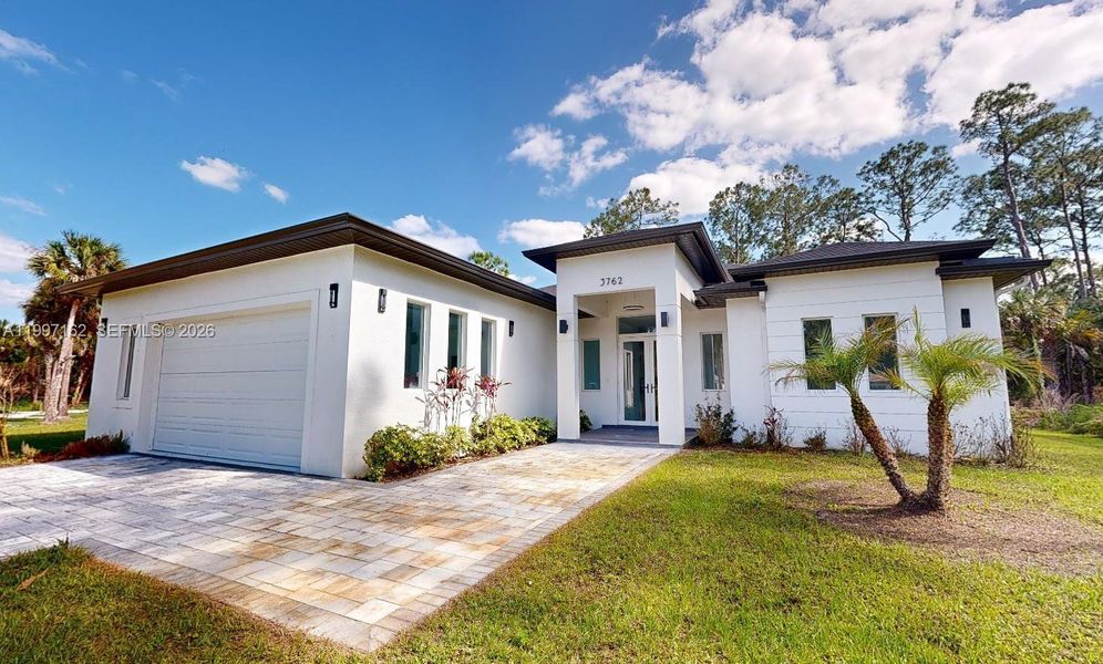 Front exterior of a new home in , Naples, FL, highlighting curb appeal (Image 27).