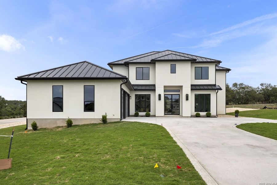 Front exterior of a new home in , Bulverde, TX, highlighting curb appeal (Image 30).