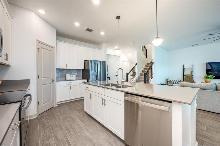 Central kitchen overlooks living room