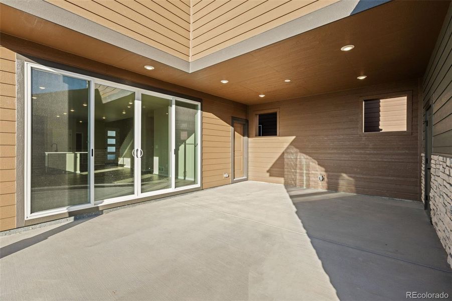 Exterior details and patio area of a home in Painted Prairie, Aurora (Image 29).