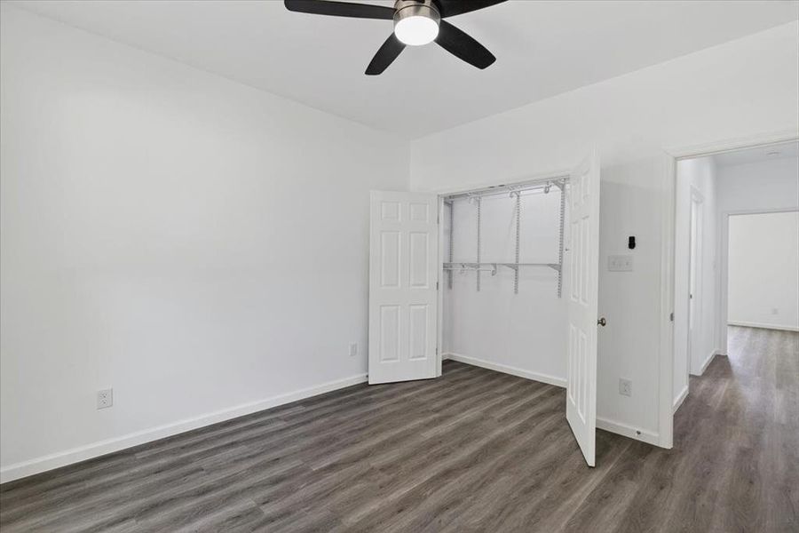Spacious closet, white painted walls, and a contemporary ceiling fan with integrated lighting