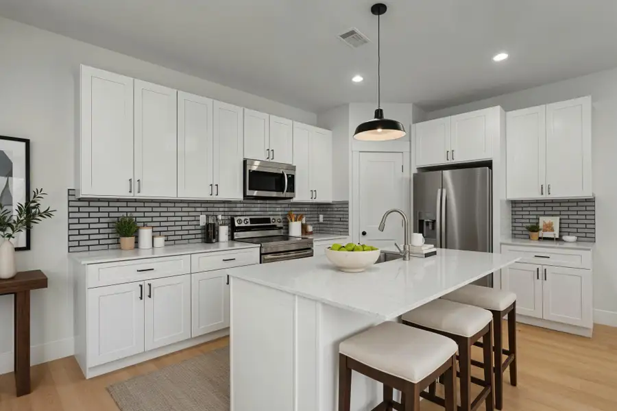 Virtually staged Kitchen featuring backsplash, a kitchen bar, light wood-type flooring, stainless steel appliances, and recessed lighting Virtually staged Kitchen featuring backsplash, a kitchen bar, light wood-type flooring, stainless steel appliances, and recessed lighting