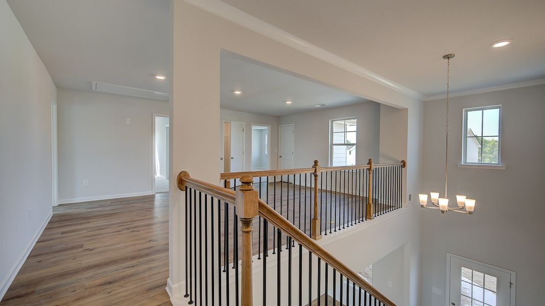 McKinley II upstairs landing with open hallway leading to loft at Brighton in Locust Grove, GA.