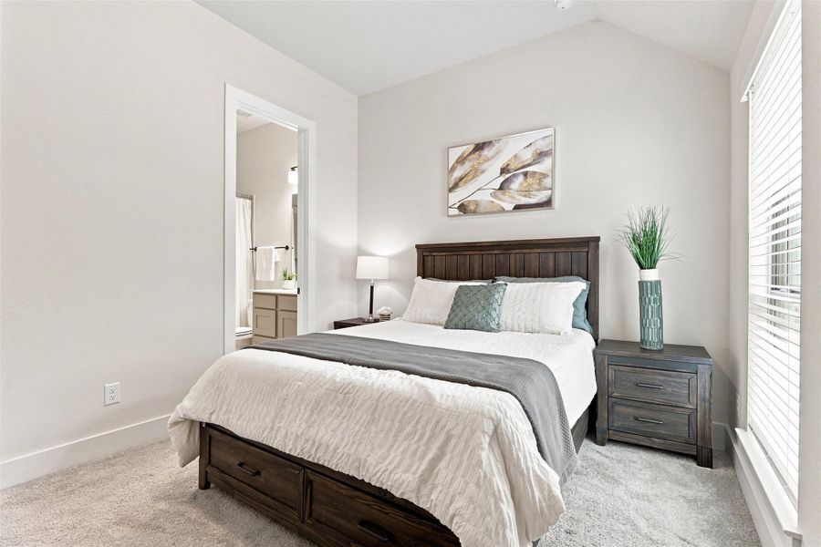 A well-lit bedroom provides direct access to a private bathroom, ensuring convenience and comfort.