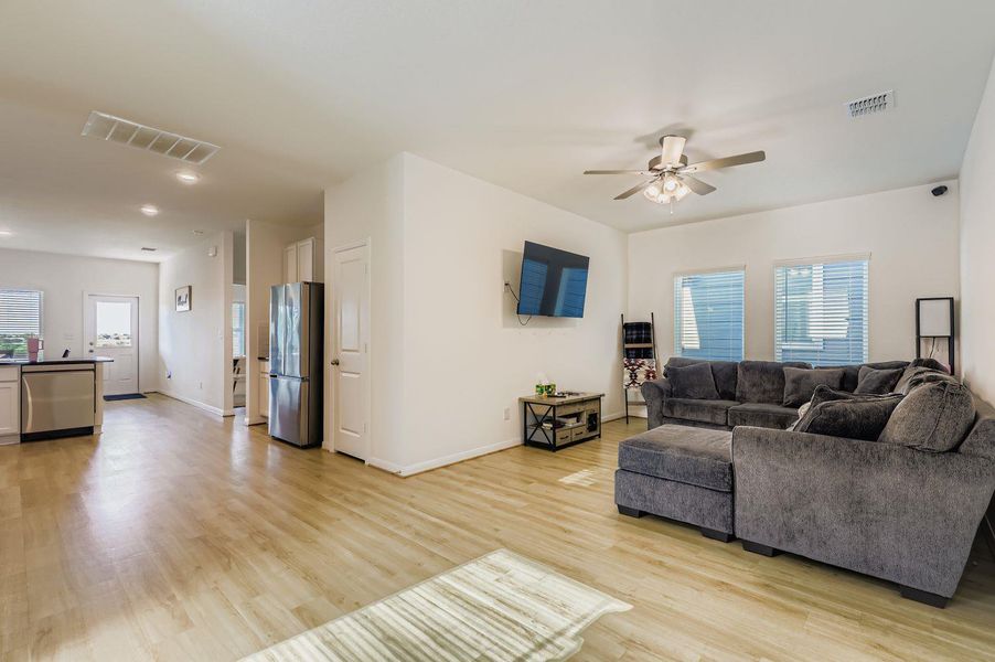 Living room featuring light wood-style floors and ceiling fan