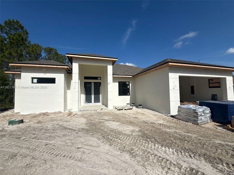 Front exterior of a new home in , Lehigh Acres, FL, highlighting curb appeal (Image 1).