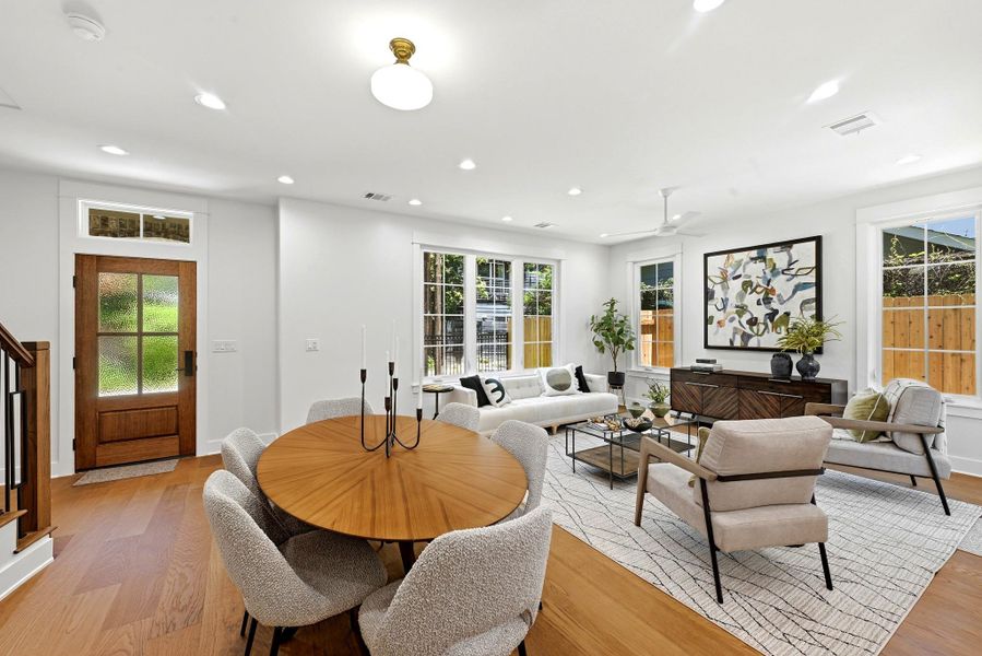 An inviting open-concept living space features warm wood flooring and abundant natural light. An inviting open-concept living space features warm wood flooring and abundant natural light.