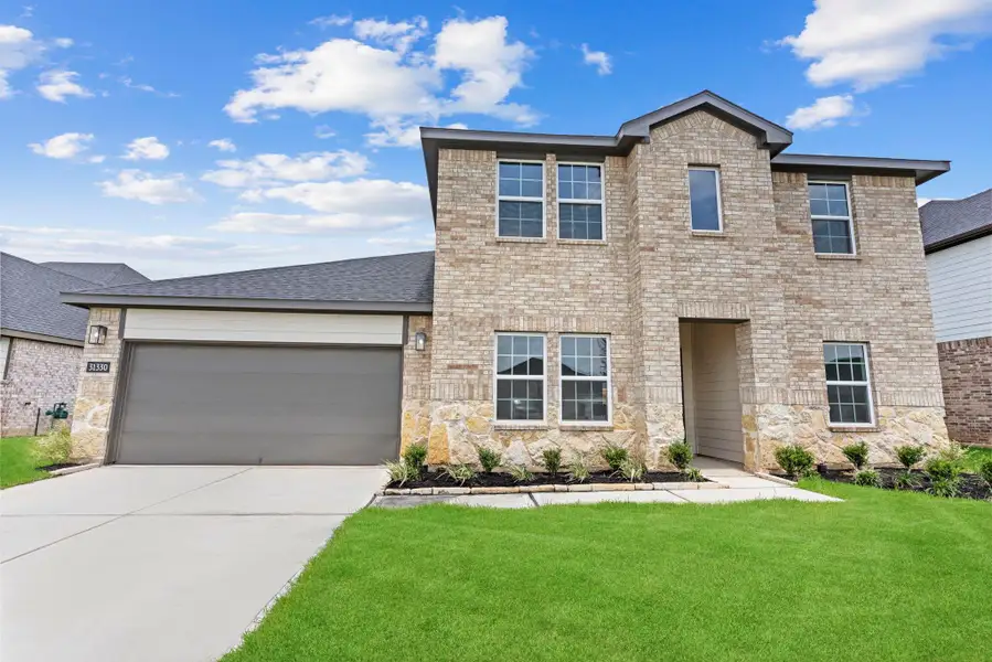 Front exterior of a new home in Tamarron, Fulshear, TX, highlighting curb appeal (Image 1). Front exterior of a new home in Tamarron, Fulshear, TX, highlighting curb appeal (Image 1).