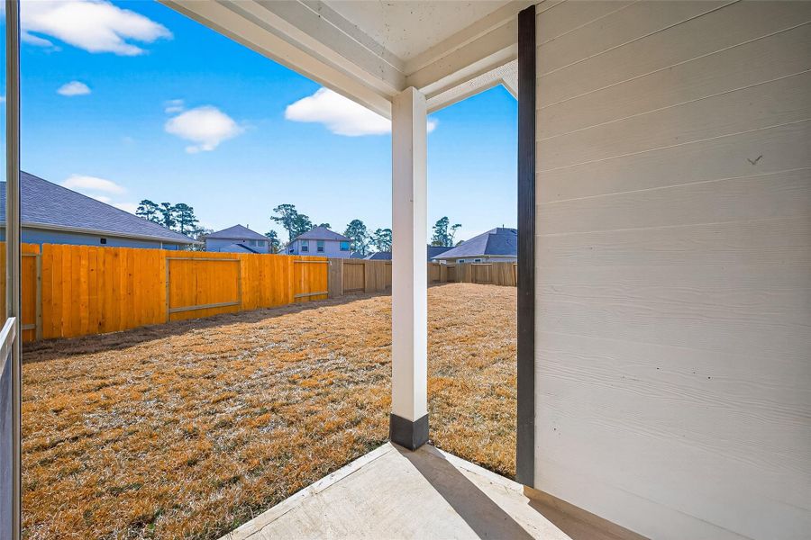 Exterior details and patio area of a home in Woodland Lakes, Huffman (Image 19).