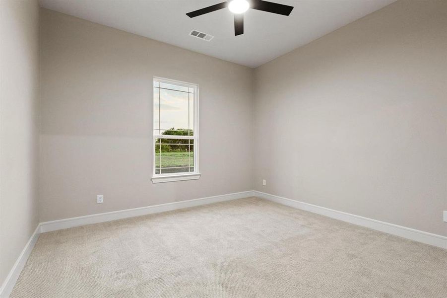 Empty room featuring light colored carpet and a ceiling fan