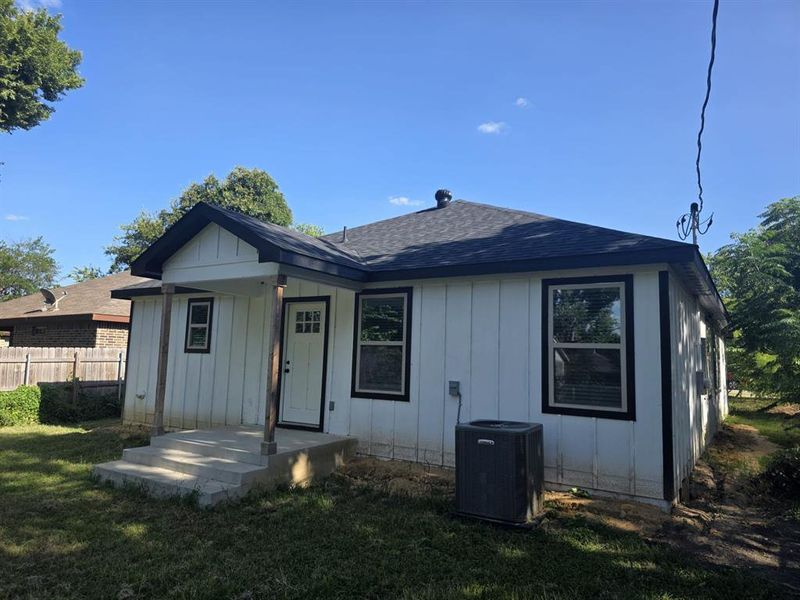 Back of house with a shingled roof and board and batten siding Back of house with a shingled roof and board and batten siding