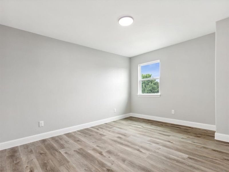 Empty room featuring wood-type flooring