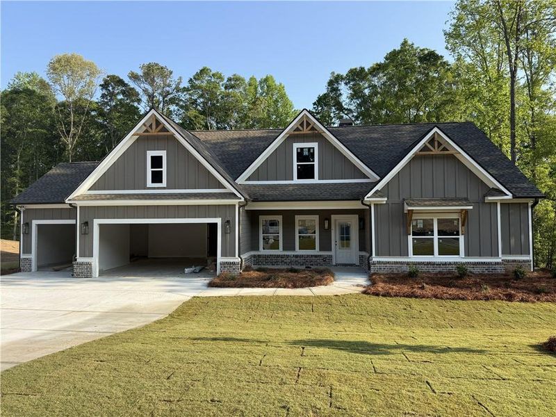 Front exterior of a new home in Woodland Hills, Loganville, GA, highlighting curb appeal (Image 1). Front exterior of a new home in Woodland Hills, Loganville, GA, highlighting curb appeal (Image 1).