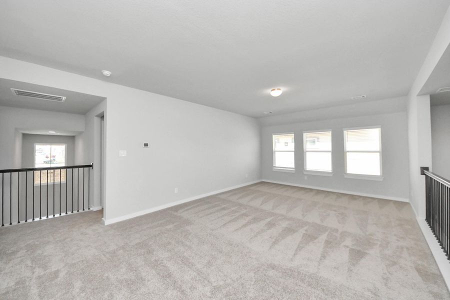 Come upstairs and enjoy a day of leisure in this fabulous game room! This is the perfect hangout spot or adult game room! Features plush carpet, high ceilings, custom paint and windows for plenty of natural light. Come upstairs and enjoy a day of leisure in this fabulous game room! This is the perfect hangout spot or adult game room! Features plush carpet, high ceilings, custom paint and windows for plenty of natural light.