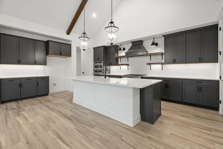 Gourmet island kitchen with grey cabinets and quartz counters (*Photo not of actual home and used for illustration purposes only.) Gourmet island kitchen with grey cabinets and quartz counters (*Photo not of actual home and used for illustration purposes only.)