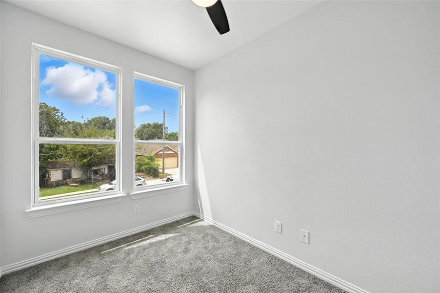 Spare room with carpet and ceiling fan