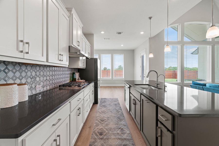 Kitchen featuring light wood-style floors, white cabinetry, hanging light fixtures, and recessed lighting Kitchen featuring light wood-style floors, white cabinetry, hanging light fixtures, and recessed lighting
