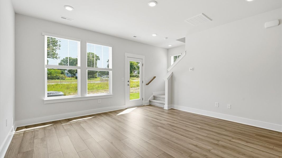 Memorable moments begin in this elegant, open family room with hardwood flooring and refined finishes at Clarke Townes