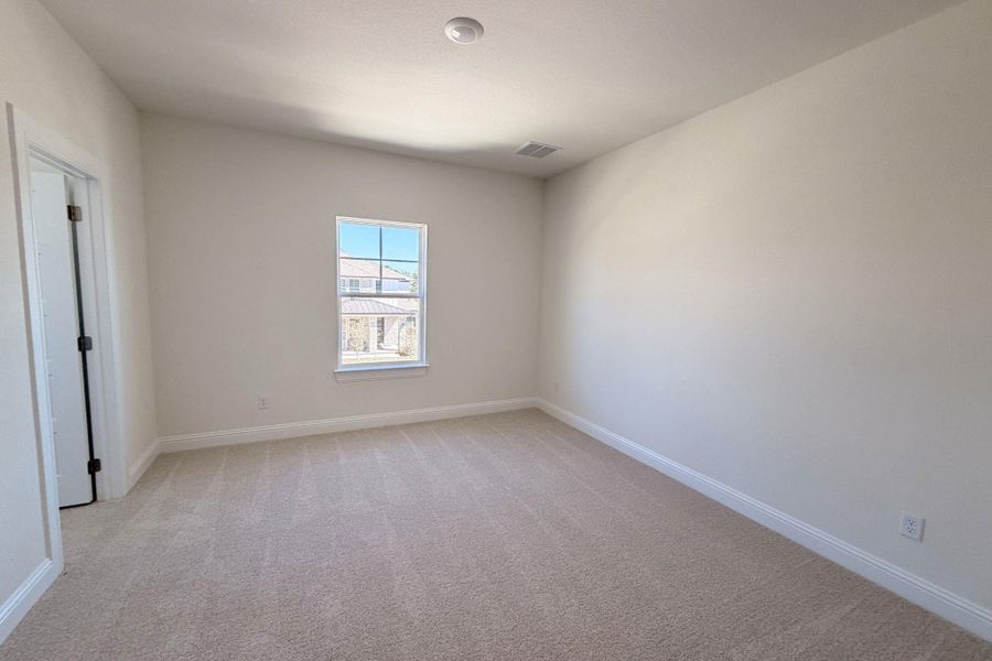 Empty room featuring baseboards and light carpet