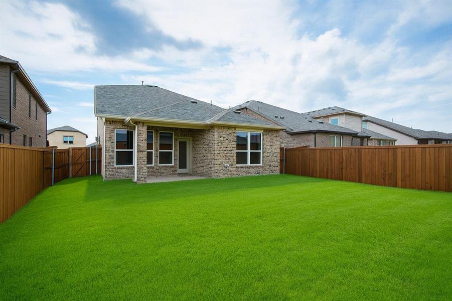 Rear view of property featuring a shingled roof, a patio, brick siding, and a fenced backyard Rear view of property featuring a shingled roof, a patio, brick siding, and a fenced backyard