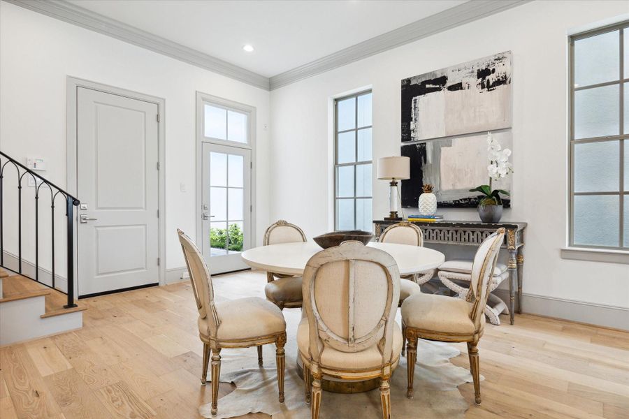 Alternate view of Dining Room. Door on left leads to Garage, glass door on right leads to Private Courtyard with patio.