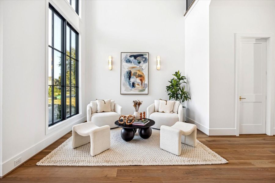Light filled sitting area just off the entry offers a welcoming pause before moving into the main living spaces. Positioned to take advantage of tall windows and open volume, it works equally well for conversation, reading, or a quiet moment at the start or end of the day. **Previous build by Arch Angelo** Light filled sitting area just off the entry offers a welcoming pause before moving into the main living spaces. Positioned to take advantage of tall windows and open volume, it works equally well for conversation, reading, or a quiet moment at the start or end of the day. **Previous build by Arch Angelo**