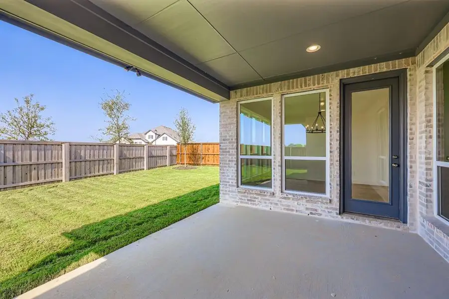 Fenced backyard with a patio