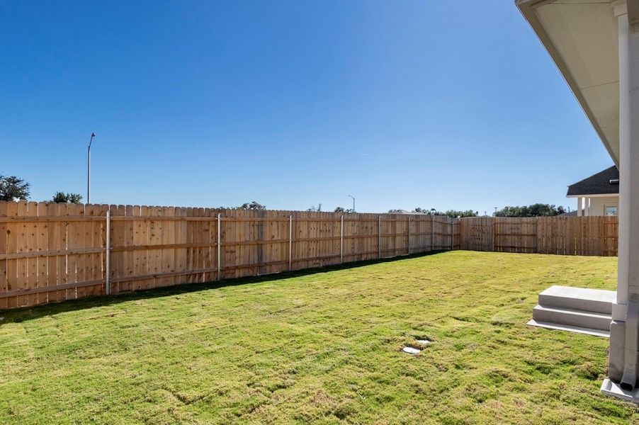 View of fenced backyard