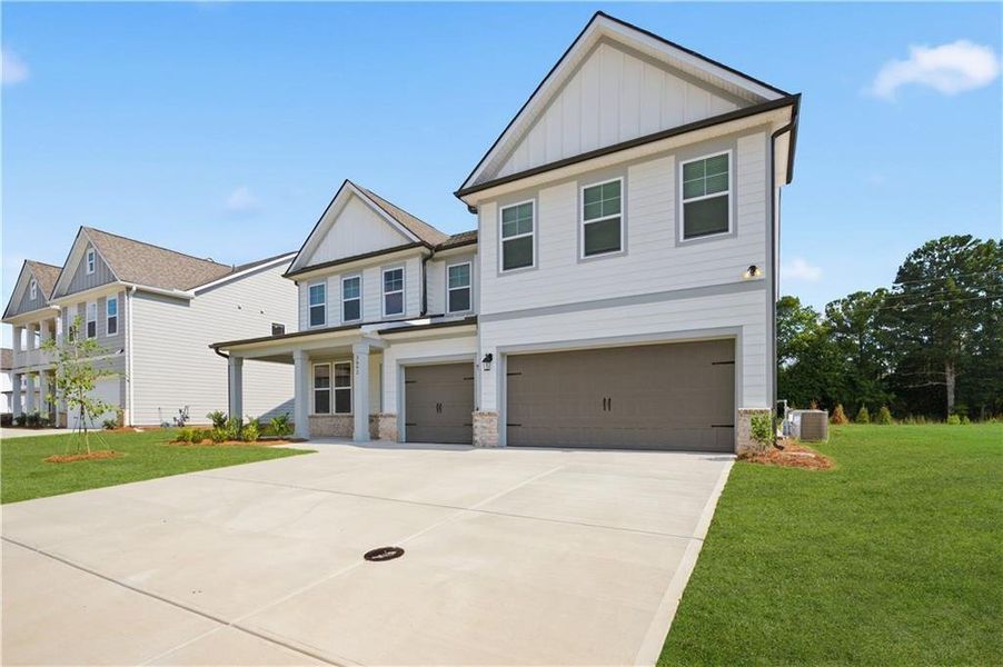 Front exterior of a new home in Northcroft, Loganville, GA, highlighting curb appeal (Image 16).