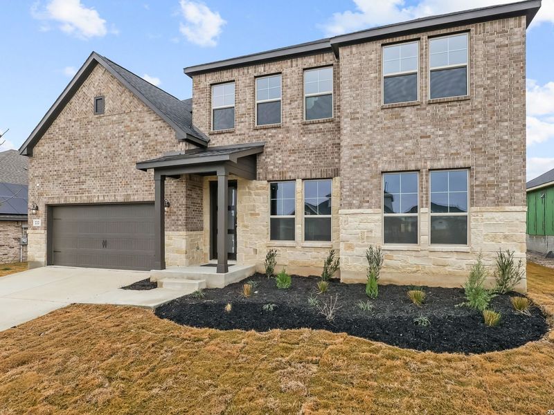 Front exterior of a new home in The Reserve at Potranco Oaks, Castroville, TX, highlighting curb appeal (Image 29).
