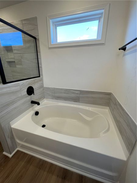 This bathroom showcases a modern tub and a sleek s