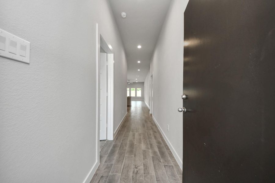 The grand entrance welcomes you with tile floors, oversized baseboards, and recessed lighting, setting the stage for a luxurious journey. Follow the Long Walkway to discover the open-concept kitchen and family room, where elegance meets comfort seamlessly. Sample photo of completed home with similar floor plan. Actual colors and selections may vary. The grand entrance welcomes you with tile floors, oversized baseboards, and recessed lighting, setting the stage for a luxurious journey. Follow the Long Walkway to discover the open-concept kitchen and family room, where elegance meets comfort seamlessly. Sample photo of completed home with similar floor plan. Actual colors and selections may vary.