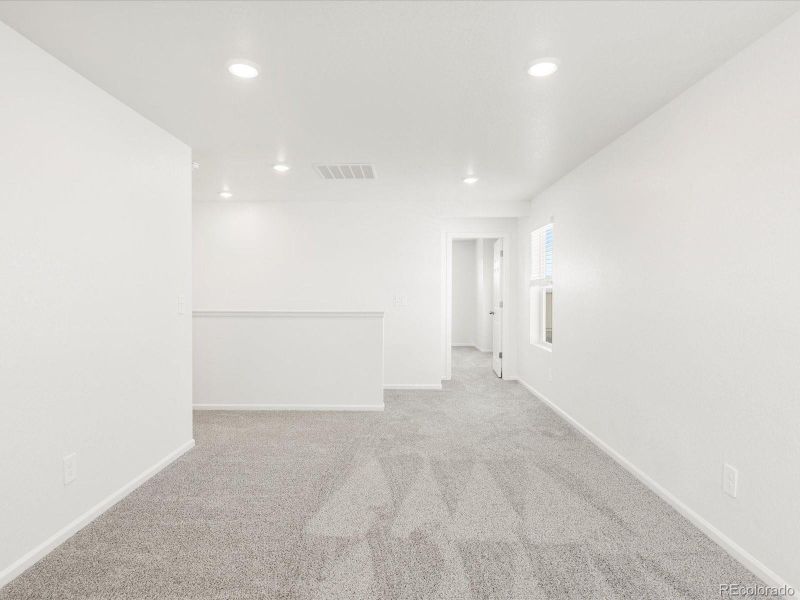 Spacious, unfurnished interior of a new home in Ridgeline Vista: The Flora Collection, Brighton (Image 17).