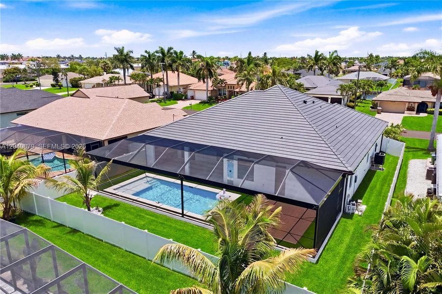 Expansive screened lanai creates the perfect outdoor retreat, offering seamless indoor-outdoor living with a private pool and ample space for relaxing or entertaining year-round