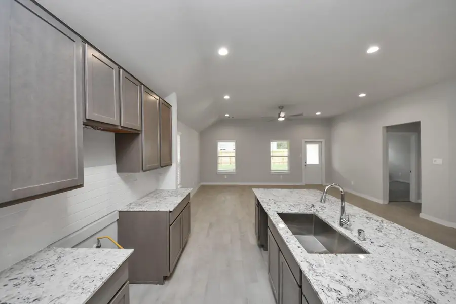 All of this overlooks your expansive family room, creating a perfect space forculinary delights and family gatherings. Sample photo of completed home with similar floor plan. Actual colors and selections may vary.