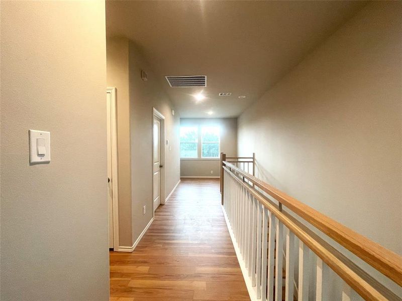 Hall with wood finished floors and baseboards