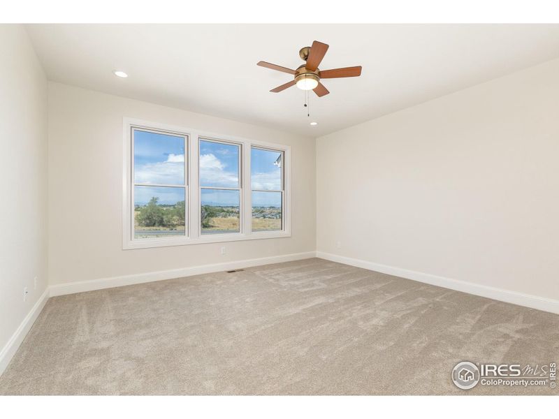 A large wall of windows looks out to the back of the house