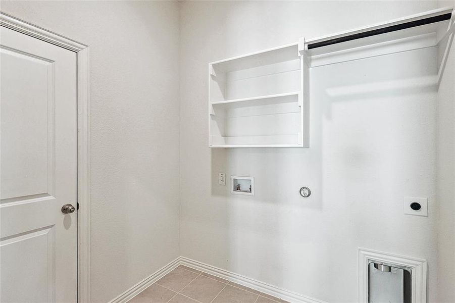 Laundry room with hookup for a washing machine, light tile patterned floors, hookup for a gas dryer, and hookup for an electric dryer