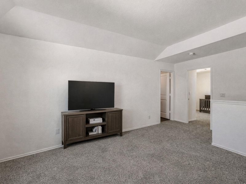 Unfurnished living room with carpet floors and lofted ceiling